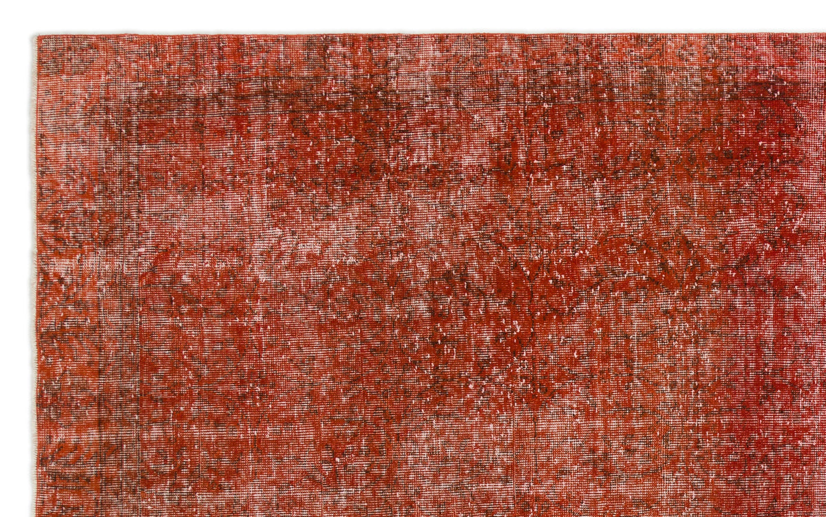 Rust-red vintage-style rug with a distressed, faded texture and subtle dark linear patterns.