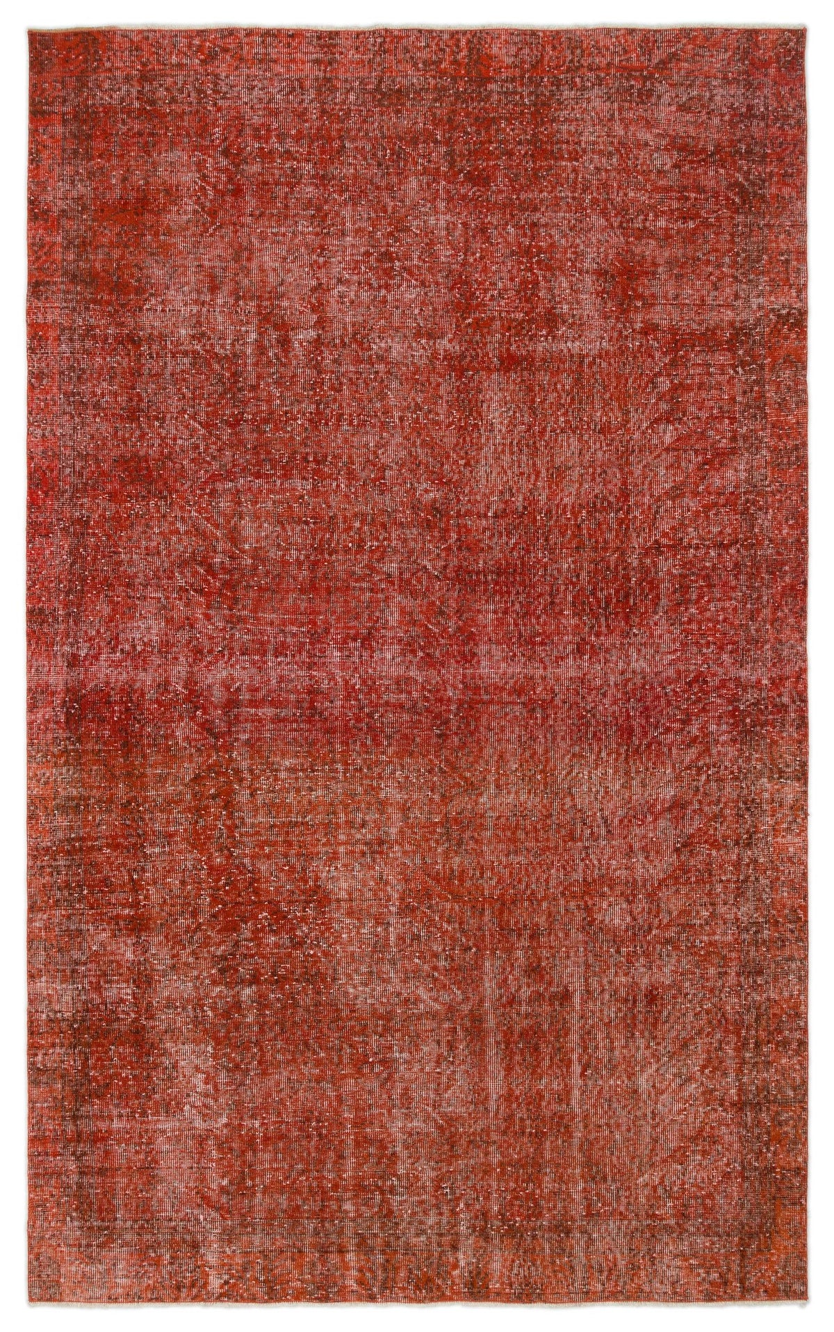 Distressed rust-red rug with a faint, traditional overdyed medallion pattern on a white background.