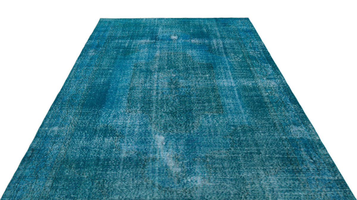 Teal distressed vintage-style rug with a faded central medallion pattern on a white background.