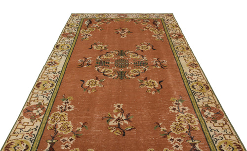 Load image 1 in gallery view. Terracotta runner rug with a central floral medallion, scattered floral motifs, and a geometric border on a white background.