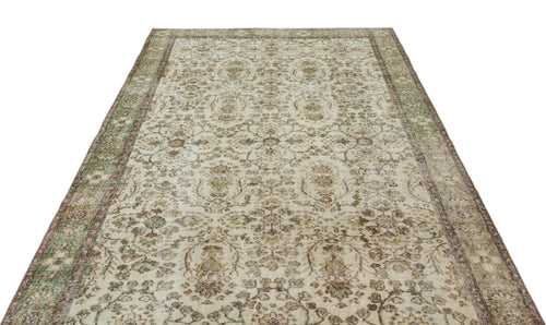 Load image 1 in gallery view. Beige and green vintage-style rug with a distressed floral medallion pattern and a decorative border.