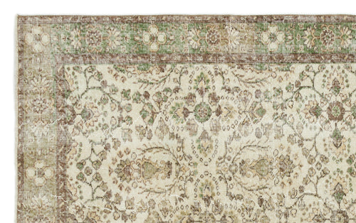 Load image 1 in gallery view. Cream, brown, and sage green vintage-style rug with a traditional floral medallion pattern and a decorative border.
