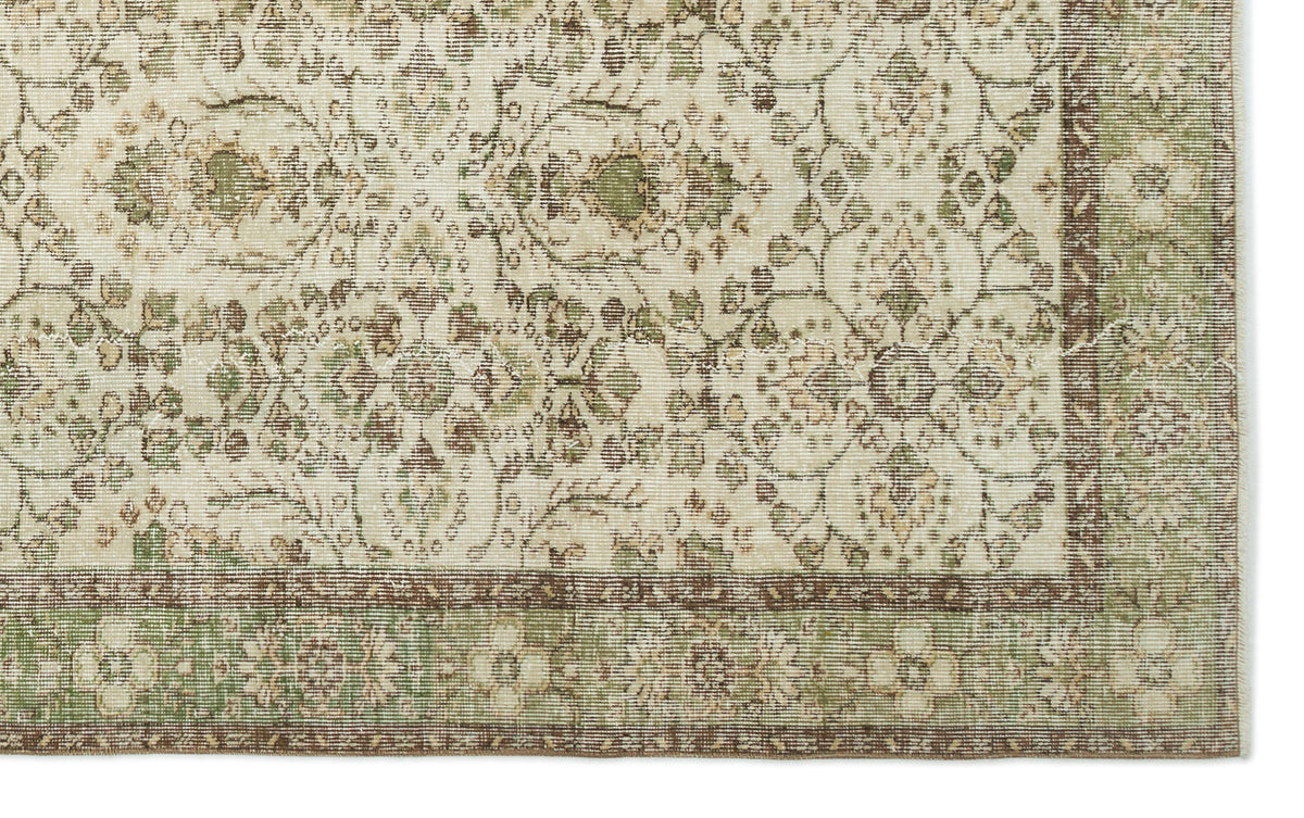 Cream, sage green, and brown rug with a traditional floral medallion pattern and a decorative border.