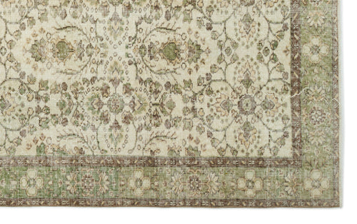 Load image 1 in gallery view. Cream, sage green, and brown rug with a traditional floral medallion pattern and a decorative border.