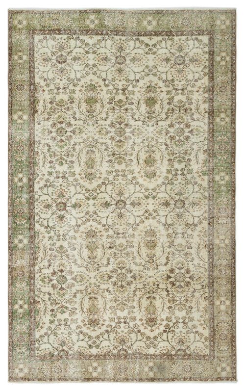 Load image 1 in gallery view. Distressed cream rug with a sage green and brown floral medallion pattern and a decorative border.