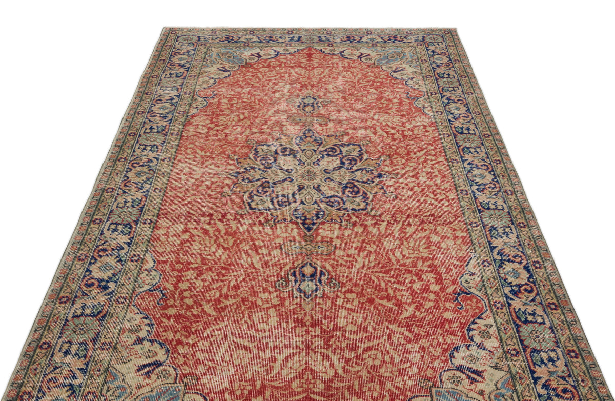 Red and blue traditional Persian-style rug with a central floral medallion and intricate border on a white background.