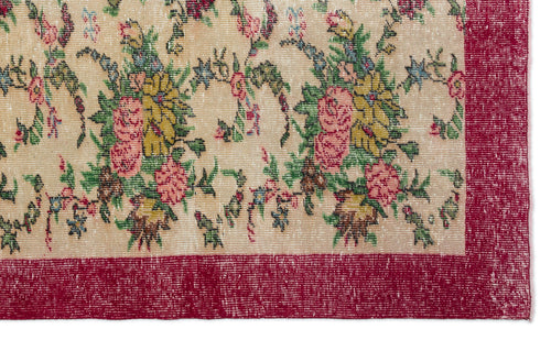 Load image 1 in gallery view. Beige rug with a distressed floral pattern in pink, yellow, and green, featuring a wide, solid red border.