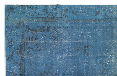 Load image 1 in gallery view. Blue distressed rug with a dark grey floral and geometric border pattern on a white background.