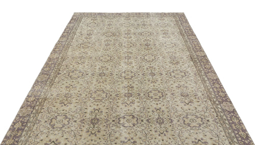 Load image 1 in gallery view. Beige and muted purple vintage-style rug with a distressed floral medallion pattern and a wide decorative border.