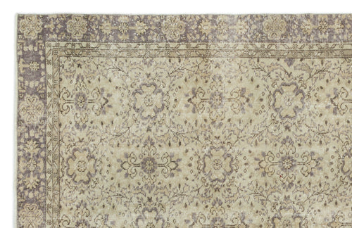 Load image 1 in gallery view. Beige and muted purple vintage-style rug with a distressed floral medallion pattern and a decorative border.