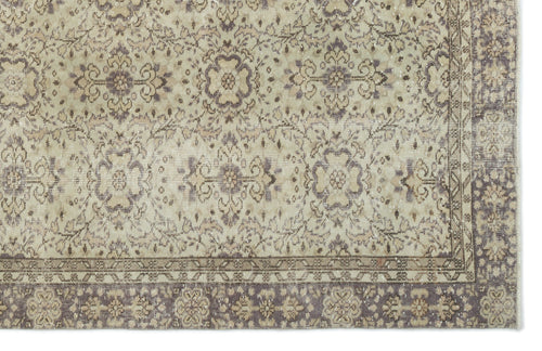 Load image 1 in gallery view. Beige and muted purple vintage-style rug with a distressed floral medallion pattern and a decorative border.