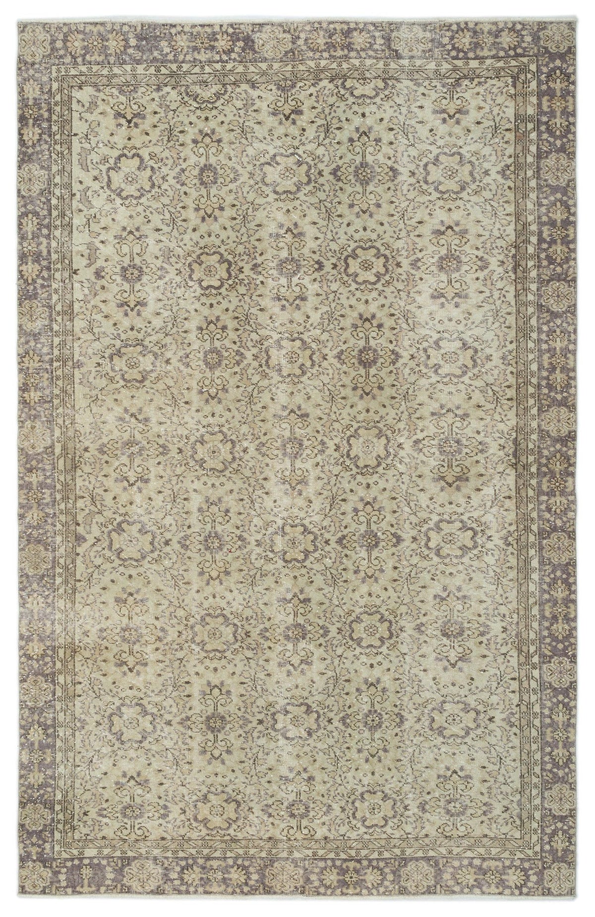Beige and muted purple vintage-style rug with a distressed floral medallion pattern and a decorative border.