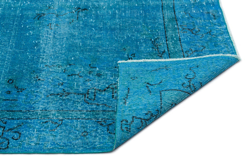 Load image 1 in gallery view. Bright blue distressed rug with a faded black geometric pattern and a folded corner, isolated on a white background.