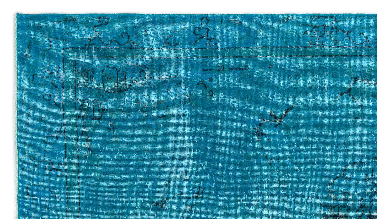 Bright turquoise rug with a distressed, faded black traditional floral border and medallion pattern.