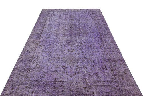 Load image 1 in gallery view. Distressed purple vintage-style rug with a dark floral medallion pattern and a bordered edge on a white background.