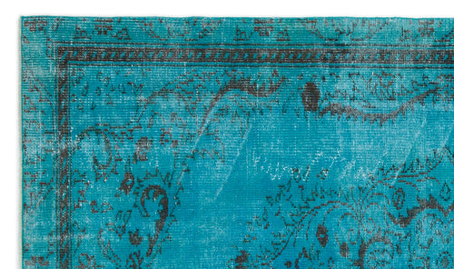 Load image 1 in gallery view. Turquoise rug with a distressed black floral medallion pattern and a decorative border.