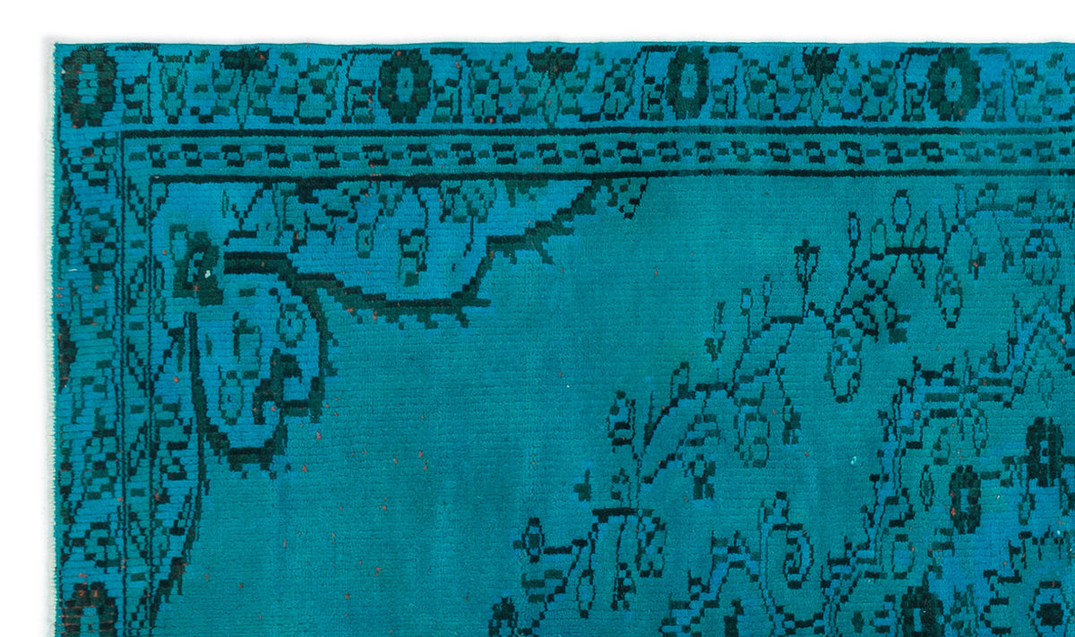 Teal rug with a black traditional floral border and central medallion pattern.