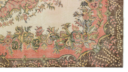 Load image 1 in gallery view. Cream rug with a floral medallion pattern in coral, green, and brown, featuring a dark brown border.