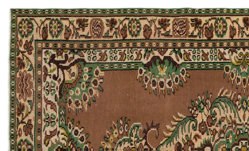 Load image 1 in gallery view. Brown, green, and cream traditional rug with a floral border and central medallion pattern.