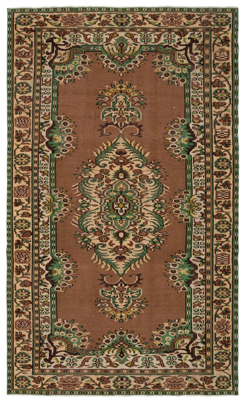 Load image 1 in gallery view. Brown traditional rug with a central green and cream floral medallion and a decorative geometric border.