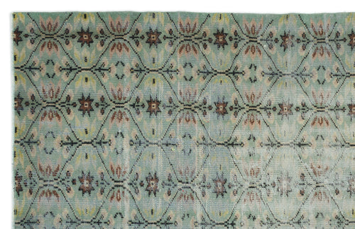 Load image 1 in gallery view. Sage green rug with a repeating diamond lattice pattern featuring brown and cream floral motifs.