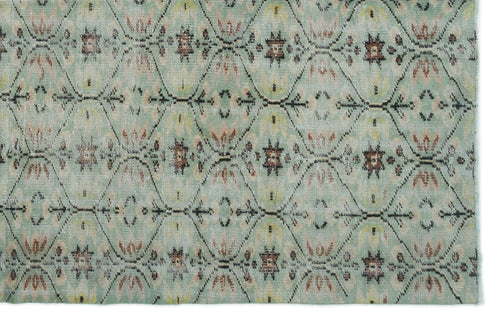 Load image 1 in gallery view. Sage green rug with a repeating dark brown diamond lattice pattern and small floral motifs in rust and yellow.