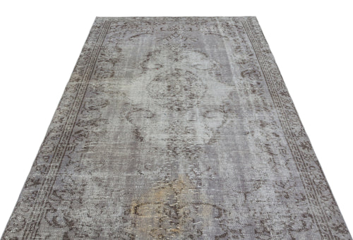 Load image 1 in gallery view. Grey and taupe vintage-style rug with a distressed central medallion and ornate border on a white background.