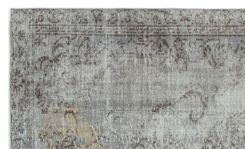 Load image 1 in gallery view. Grey and brown distressed rug with a faded traditional floral medallion pattern.
