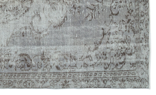 Load image 1 in gallery view. Grey and taupe distressed rug with a faded traditional floral pattern and a geometric border.
