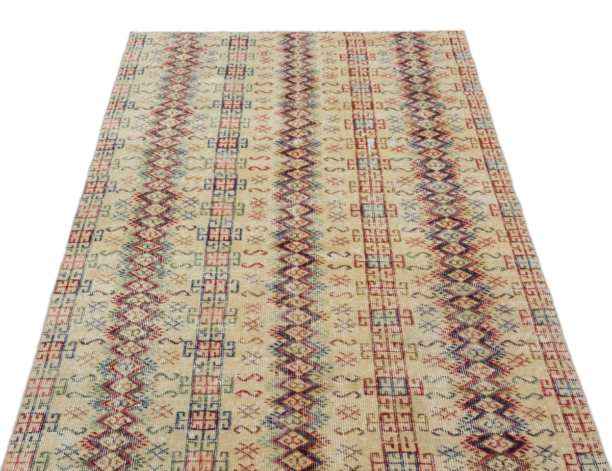 Beige rug with vertical stripes of red, blue, and green geometric diamond and grid patterns.