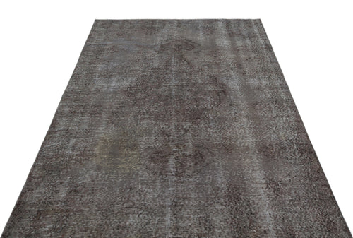 Load image 1 in gallery view. Dark charcoal distressed rug with a faded traditional medallion pattern on a white background.