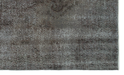 Load image 1 in gallery view. Charcoal grey distressed rug with a faded traditional floral medallion pattern.