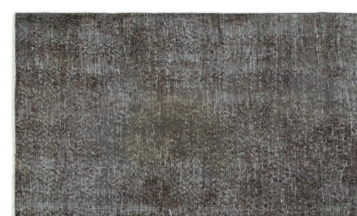 Dark charcoal and grey distressed vintage-style rug with a faded, low-pile texture.