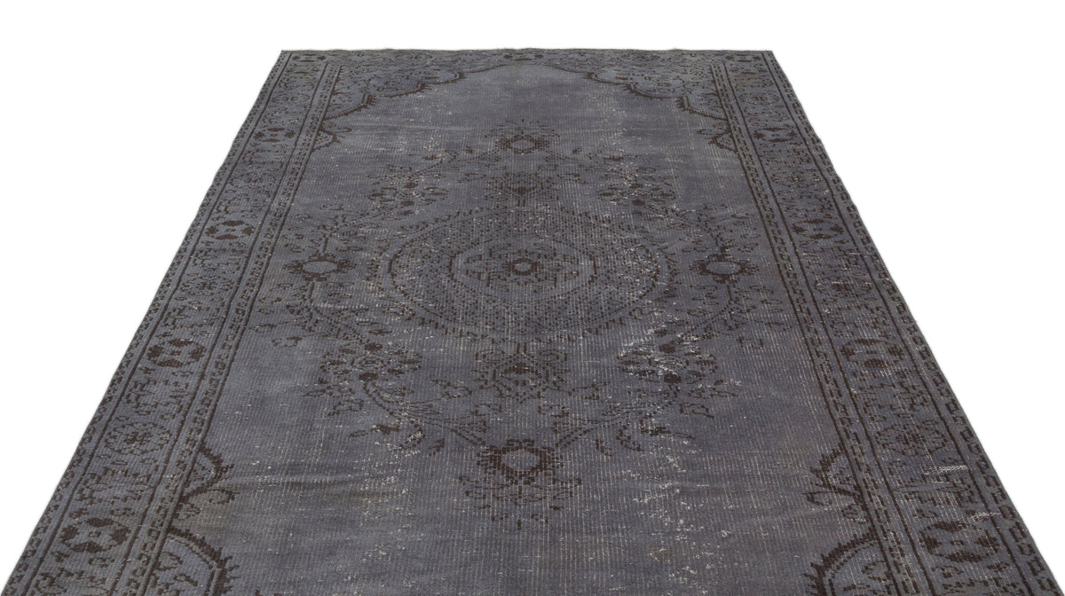 Charcoal grey distressed rug with a traditional central medallion and ornate border pattern on a white background.