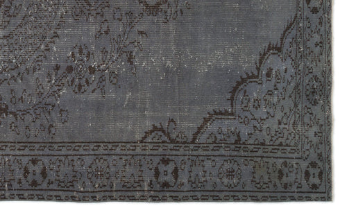 Load image 1 in gallery view. Charcoal grey distressed rug with a faded floral medallion pattern and a geometric border.