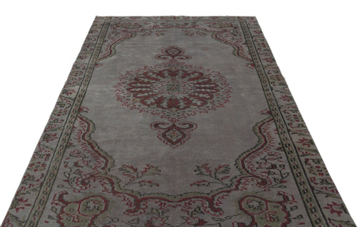 Load image 1 in gallery view. Grey vintage-style rug with a central red and olive green floral medallion and a decorative border.