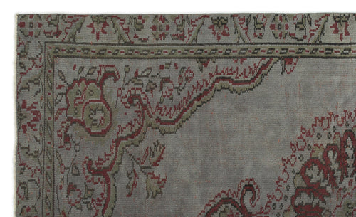 Load image 1 in gallery view. Grey rug with a distressed traditional floral medallion pattern in muted red and olive green.