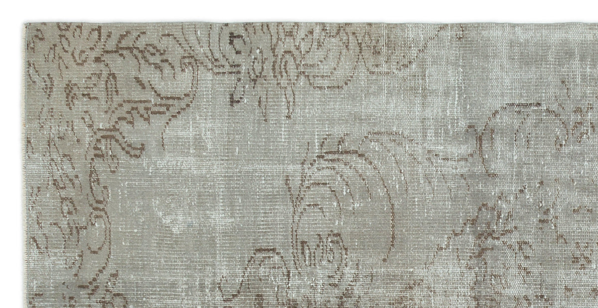Grey and taupe vintage-style rug with a faded, distressed floral medallion pattern.