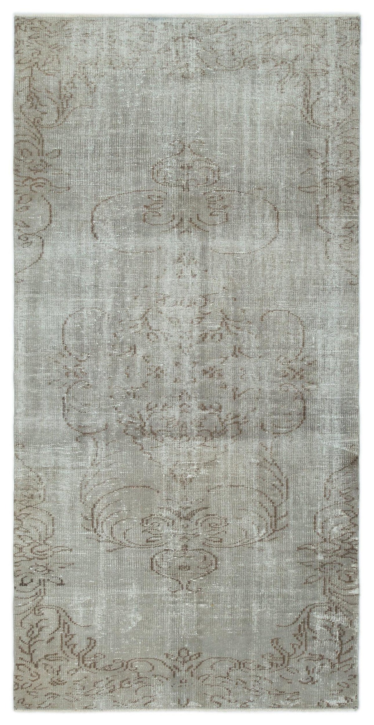 Grey and taupe distressed rug with a faded central floral medallion pattern on a white background.