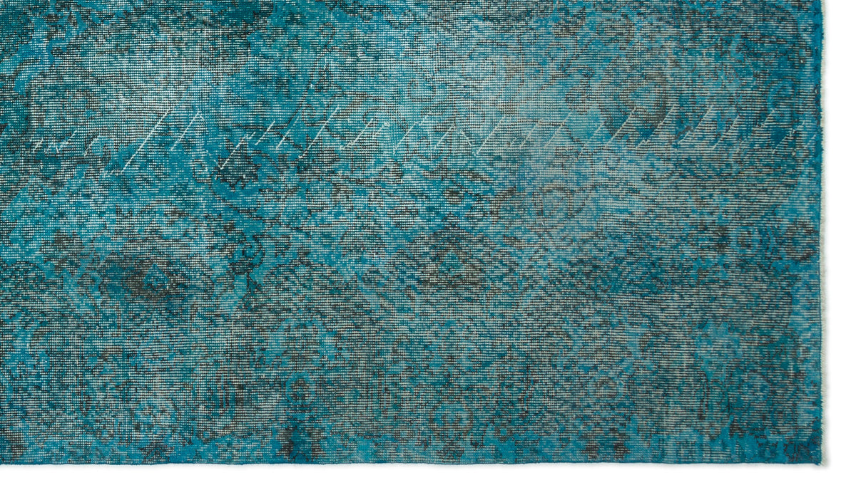 Teal and charcoal distressed rug with a faded traditional medallion pattern.