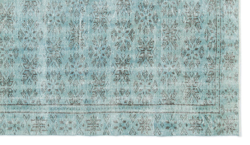Load image 1 in gallery view. Light blue distressed rug with a dark grey repeating floral medallion pattern and a bordered edge.