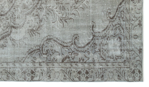 Load image 1 in gallery view. Grey and brown distressed rug with a traditional ornate floral medallion pattern and a bordered edge.