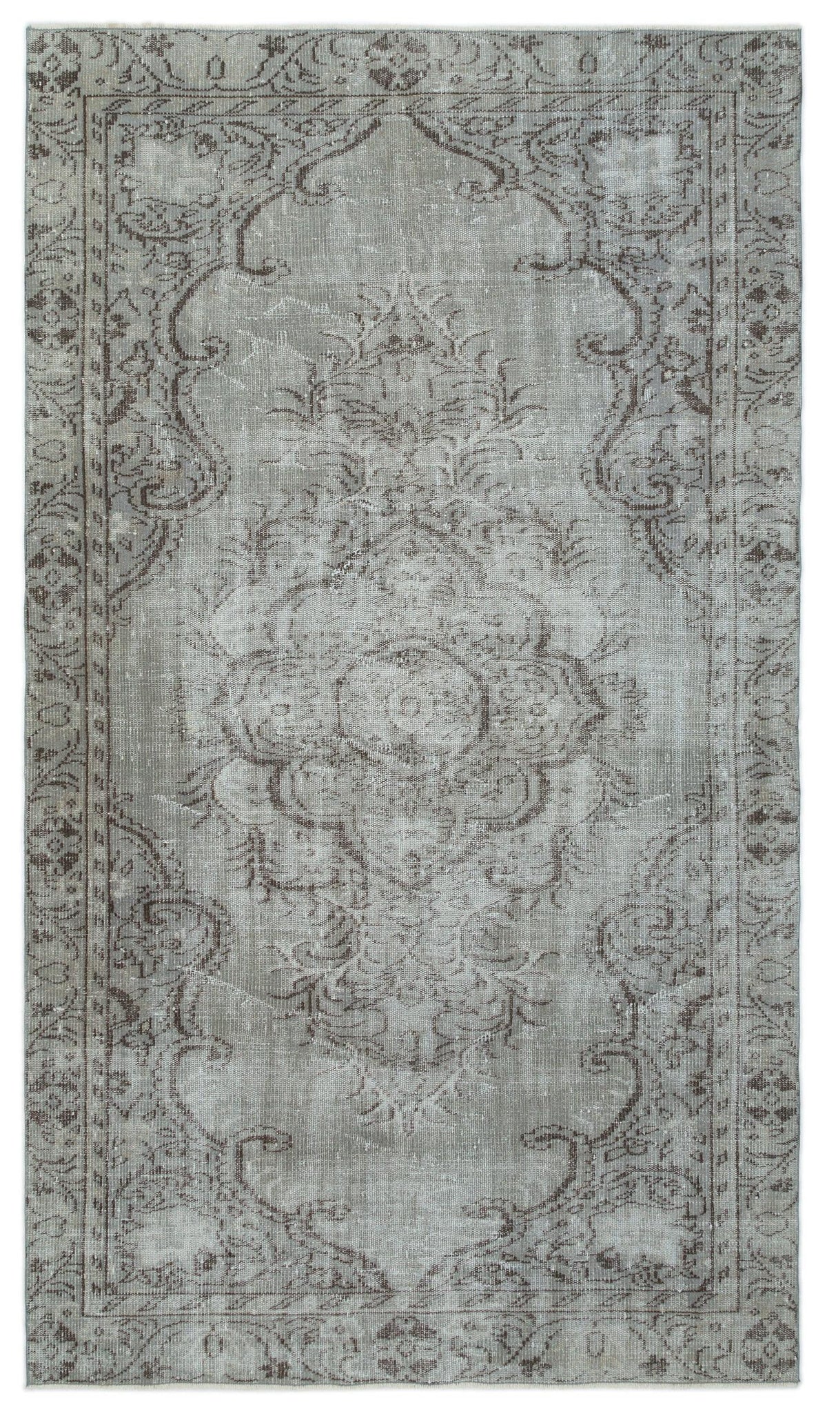 Grey and taupe distressed traditional rug with a central floral medallion and ornate border pattern.