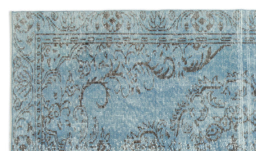 Load image 1 in gallery view. Light blue and charcoal grey rug with a distressed, traditional floral medallion pattern.