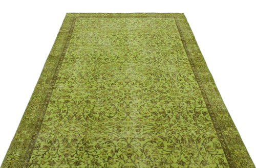 Load image 1 in gallery view. Chartreuse and olive green vintage-style rug with a distressed floral medallion pattern and a wide border.