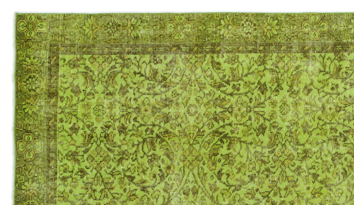 Chartreuse and olive green vintage-style rug with a traditional floral medallion pattern and a detailed border.