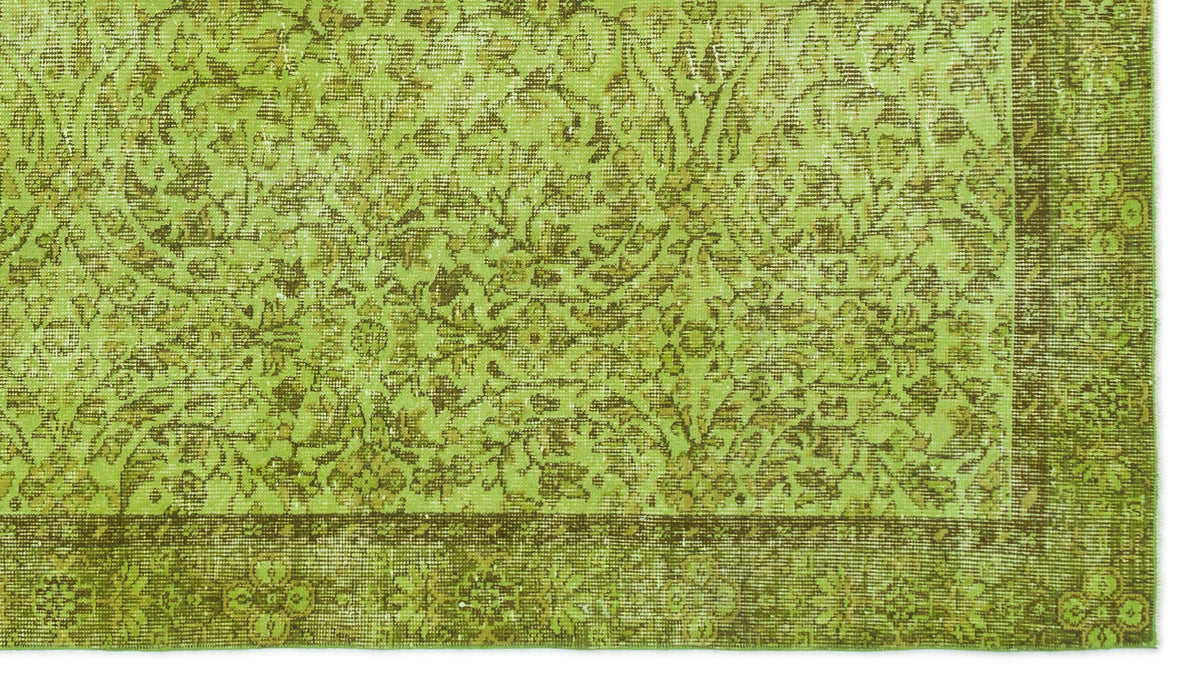 Chartreuse and olive green rug with a distressed traditional floral medallion pattern and a wide decorative border.