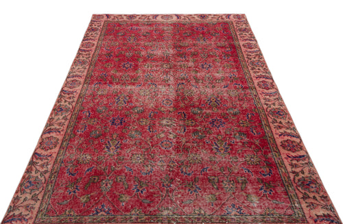 Load image 1 in gallery view. Distressed red Persian-style rug with a faded floral medallion pattern and a wide, muted pink border.