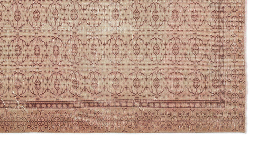Load image 1 in gallery view. Dusty rose and beige vintage-style rug with a repeating geometric medallion pattern and a decorative border.