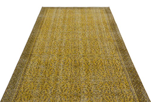 Load image 1 in gallery view. Mustard yellow and brown vintage-style rug with an intricate floral medallion pattern and a wide decorative border.